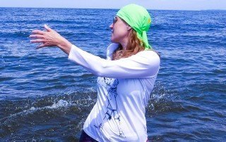 woman in a lake with Uv blocking sun hat