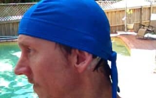 man with cochlear implants swim cap in the pool