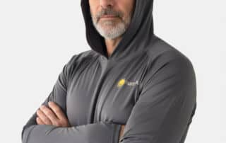 a man wearing gray sun protective swim shirt with hood