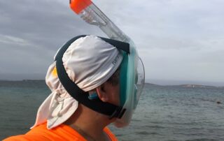 Katrina with cochlear implants snorkel hat on the beach