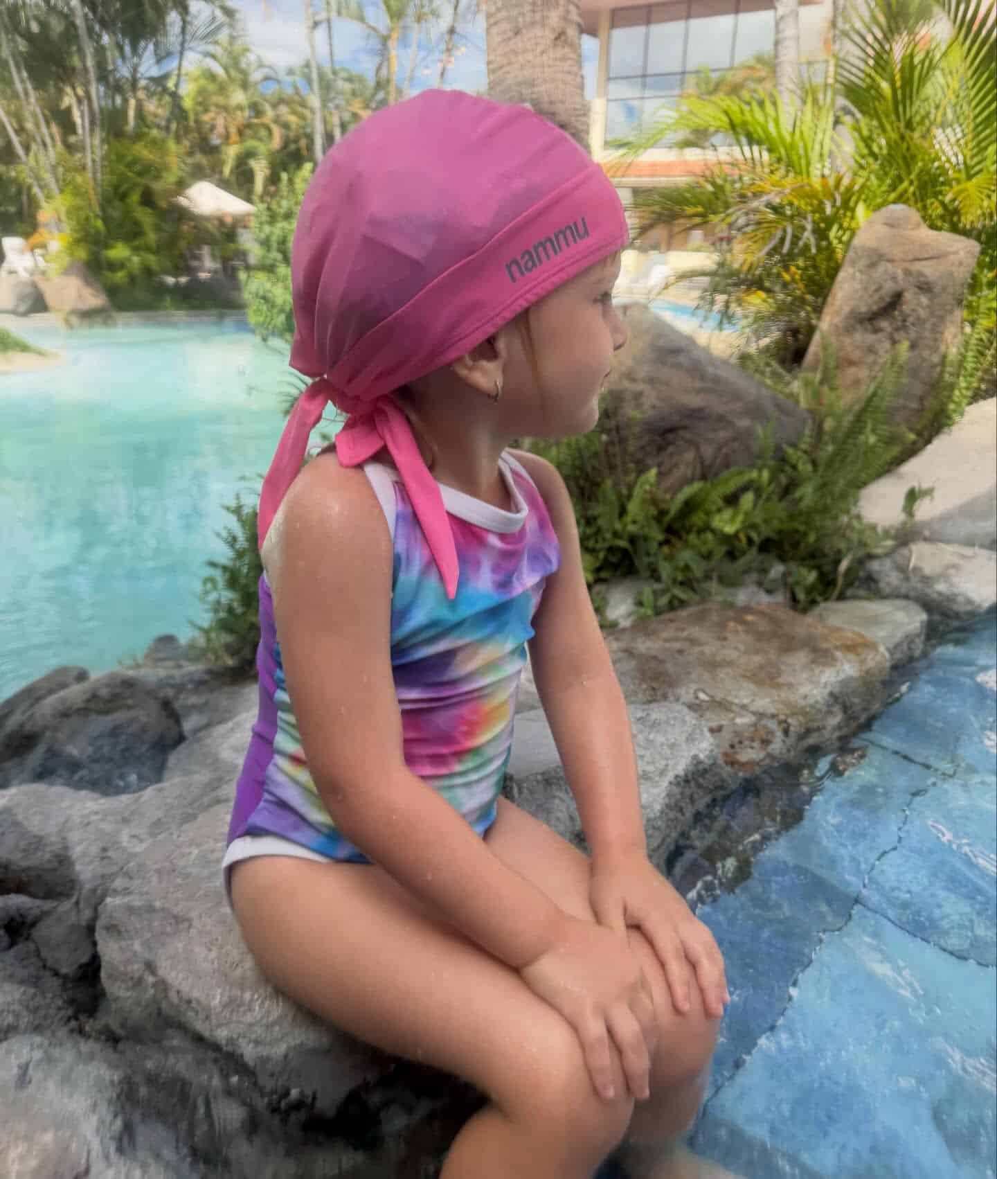flavia Kids wearing Nammu swim hats designed for cochlear implants, providing sun protection and a secure fit